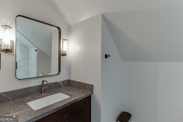 4621 Stanley Rd, Flowery Branch, GA 30542 - bathroom with lofted ceiling and vanity