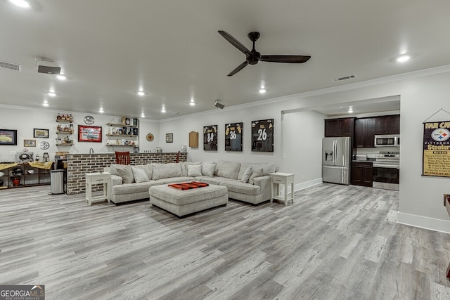 4621 Stanley Rd, Flowery Branch, GA 30542 - living area featuring crown molding, wet bar, a ceiling fan, light wood-style floors, and baseboards