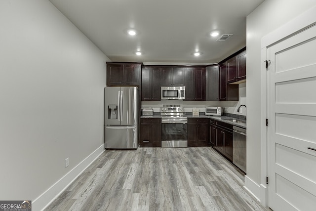 4621 Stanley Rd, Flowery Branch, GA 30542 - kitchen with stainless steel appliances, a sink, light wood-style flooring, recessed lighting, and baseboards