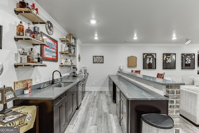 4621 Stanley Rd, Flowery Branch, GA 30542 - indoor wet bar featuring ornamental molding, light wood-style flooring, stainless steel dishwasher, baseboards, and recessed lighting