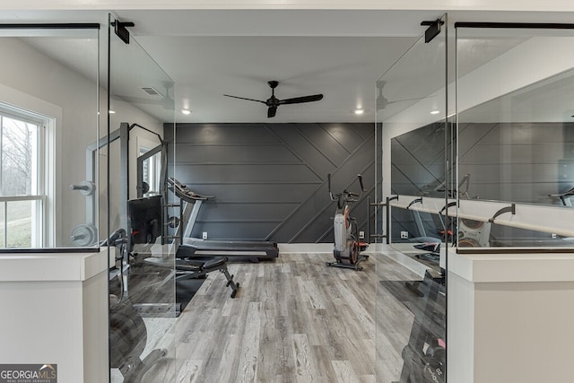 4621 Stanley Rd, Flowery Branch, GA 30542 - exercise area featuring wood finished floors, a ceiling fan, and a decorative wall