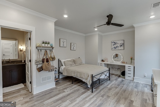 4621 Stanley Rd, Flowery Branch, GA 30542 - bedroom featuring ornamental molding, light wood-type flooring, a sink, recessed lighting, and ensuite bath