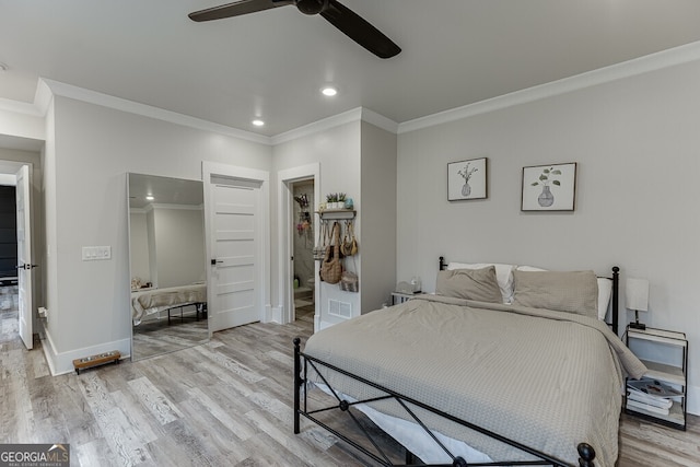 4621 Stanley Rd, Flowery Branch, GA 30542 - bedroom featuring crown molding, a walk in closet, light wood-style floors, recessed lighting, and a closet
