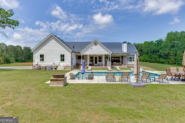 4621 Stanley Rd, Flowery Branch, GA 30542 - rear view of house with a fire pit, a patio area, a lawn, and an outdoor pool