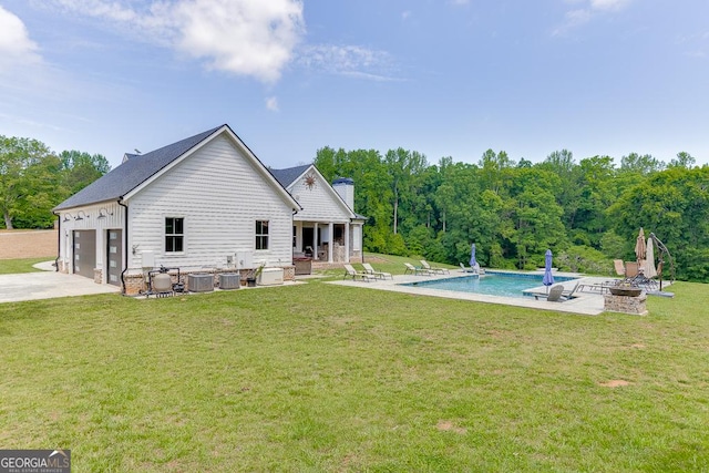 4621 Stanley Rd, Flowery Branch, GA 30542 - rear view of house with an outdoor fire pit, a patio area, cooling unit, a lawn, and driveway