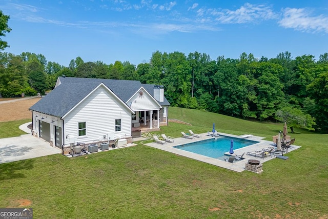 4621 Stanley Rd, Flowery Branch, GA 30542 - back of property with central air condition unit, a patio, a chimney, and a yard