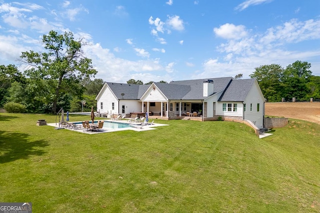 4621 Stanley Rd, Flowery Branch, GA 30542 - rear view of house featuring a patio area, a lawn, an outdoor pool, and roof with shingles