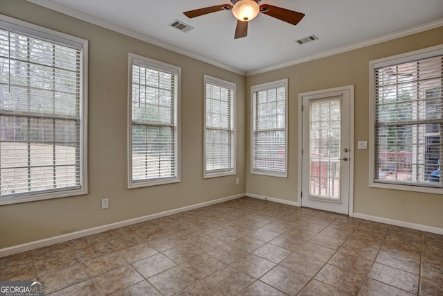 tiled spare room with ceiling fan, plenty of natural light, and crown molding