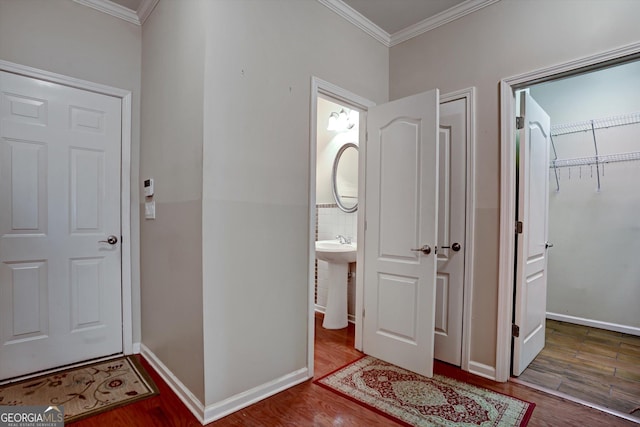 interior space with hardwood / wood-style flooring and crown molding