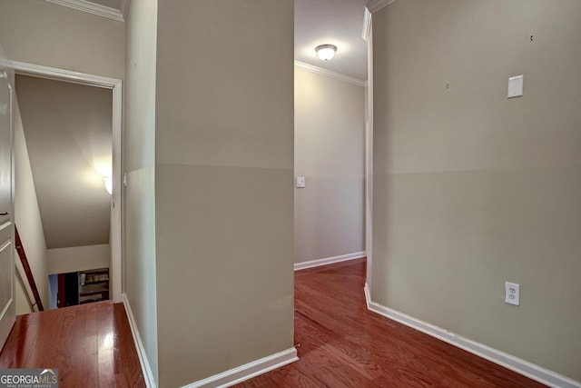 corridor with wood-type flooring and crown molding