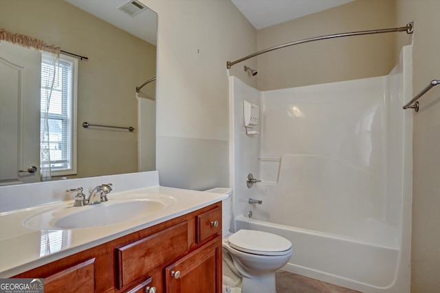 full bathroom featuring toilet, vanity, tile patterned floors, and washtub / shower combination