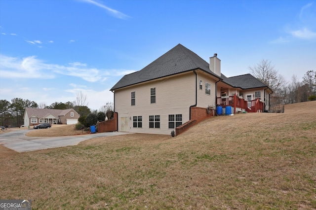 view of property exterior with a lawn and a garage