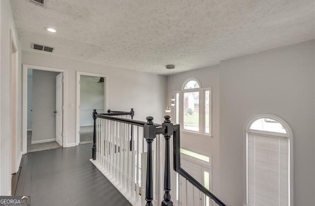 hallway featuring a textured ceiling