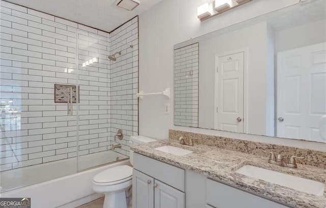 full bathroom featuring toilet, vanity, and tiled shower / bath