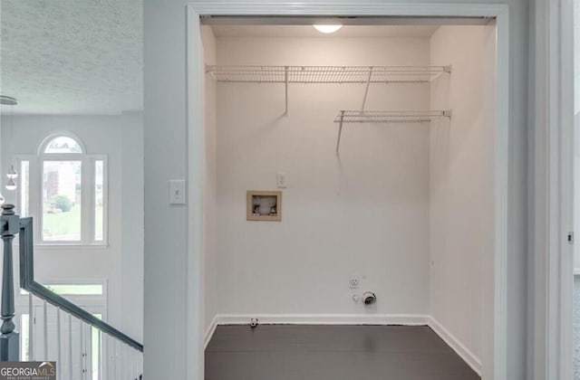 laundry area featuring washer hookup, hookup for a gas dryer, and a textured ceiling