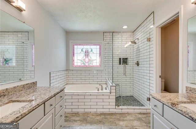 full bathroom with toilet, vanity, tile patterned flooring, independent shower and bath, and a textured ceiling