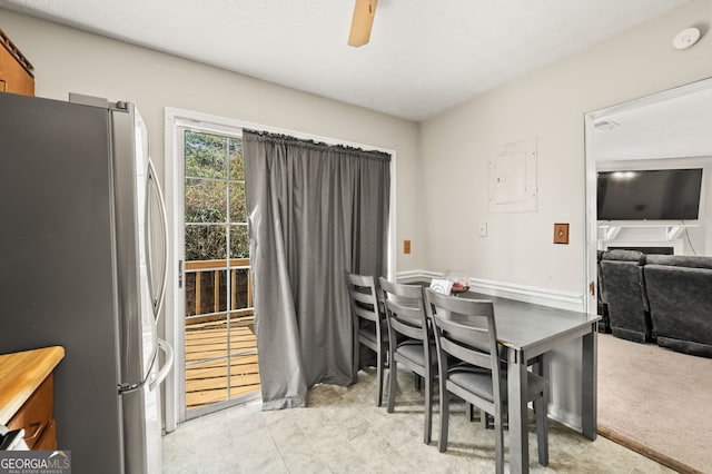 carpeted dining space with ceiling fan