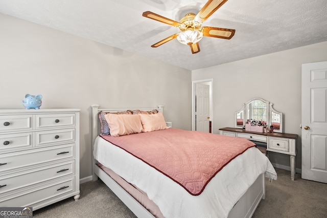 carpeted bedroom with ceiling fan and a textured ceiling