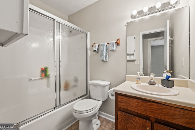 full bathroom with vanity, shower / bath combination with glass door, and toilet