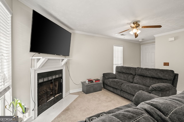 living room with crown molding, light colored carpet, and ceiling fan