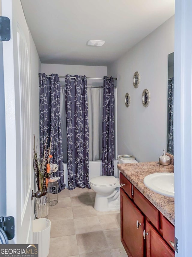 full bathroom with shower / bath combo with shower curtain, tile patterned floors, toilet, and vanity