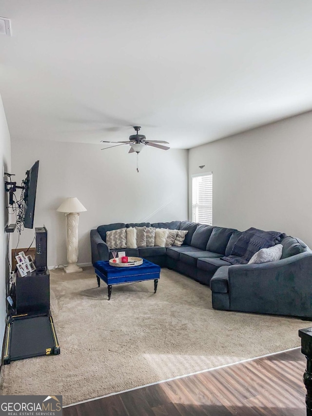 living room featuring ceiling fan and hardwood / wood-style floors