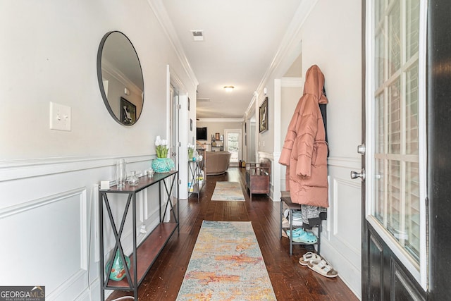 corridor with dark wood-type flooring and ornamental molding