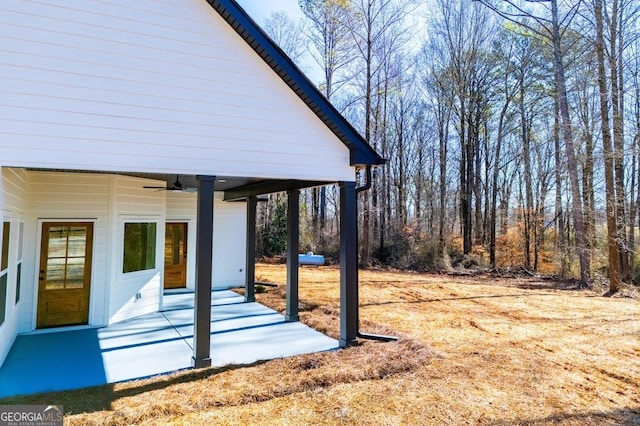 view of yard featuring a patio area and a ceiling fan