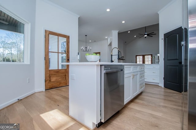 kitchen featuring white cabinetry, stainless steel appliances, decorative light fixtures, light wood-type flooring, and a kitchen island with sink