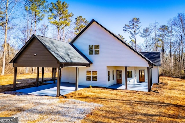 modern farmhouse style home featuring a garage, a porch, and a carport