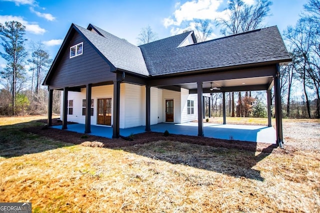 exterior space with ceiling fan, a patio, a shingled roof, and a front yard