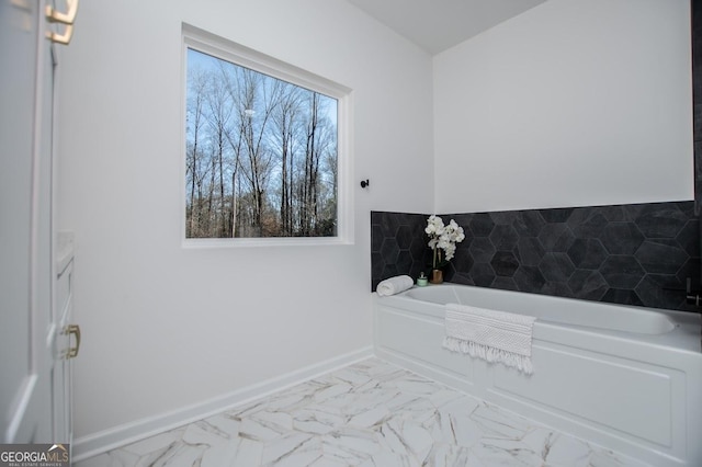 bathroom featuring tile walls, vanity, and a bathing tub