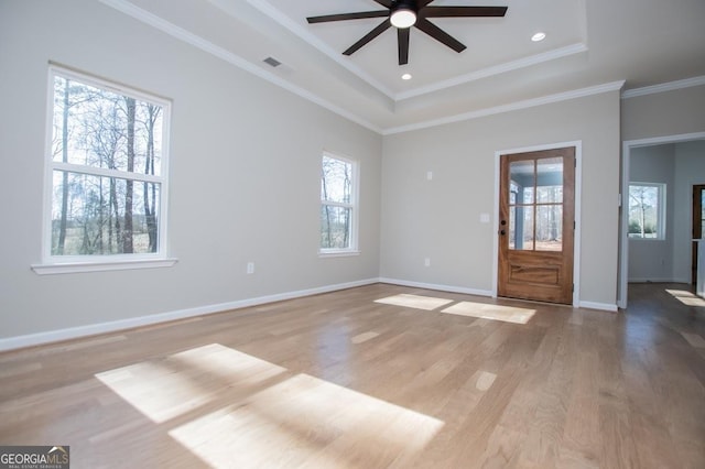 interior space with light wood finished floors, recessed lighting, visible vents, ornamental molding, and baseboards