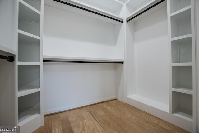 spacious closet with light hardwood / wood-style floors