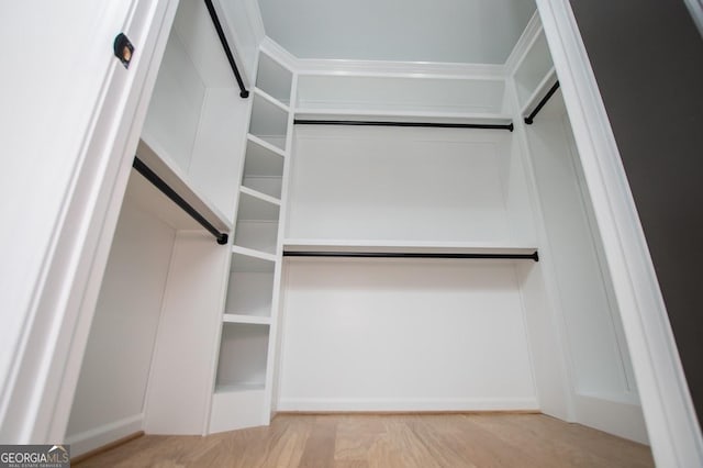 walk in closet featuring light hardwood / wood-style flooring