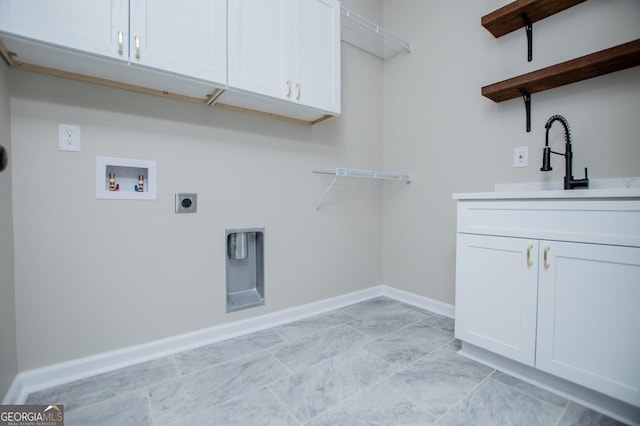 laundry area with hookup for a washing machine, cabinets, sink, and electric dryer hookup