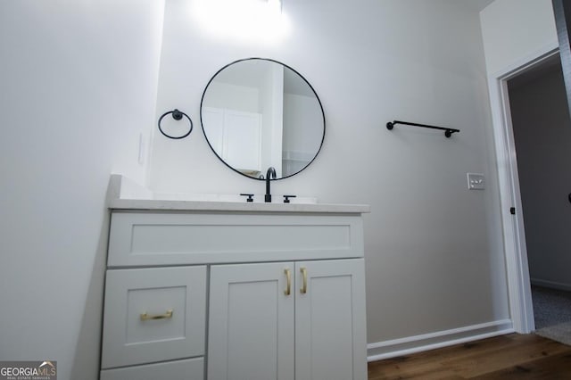 bathroom featuring hardwood / wood-style flooring and vanity