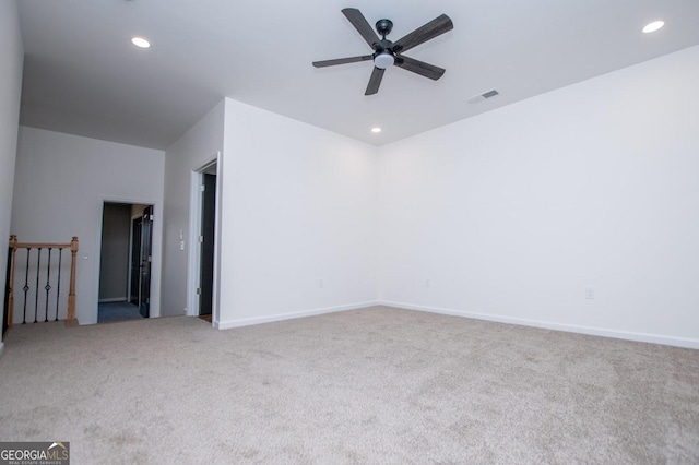 empty room with ceiling fan and light colored carpet