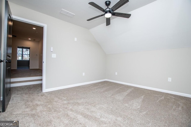 additional living space with lofted ceiling, ceiling fan, carpet, and baseboards