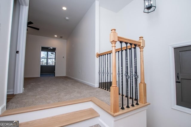 staircase with carpet floors, baseboards, and recessed lighting