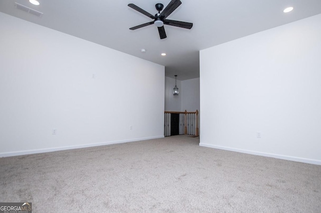 carpeted spare room with ceiling fan, visible vents, baseboards, and recessed lighting