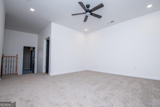 carpeted empty room featuring baseboards, ceiling fan, visible vents, and recessed lighting