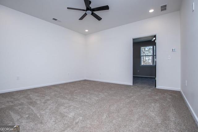 empty room with carpet floors, recessed lighting, visible vents, ceiling fan, and baseboards