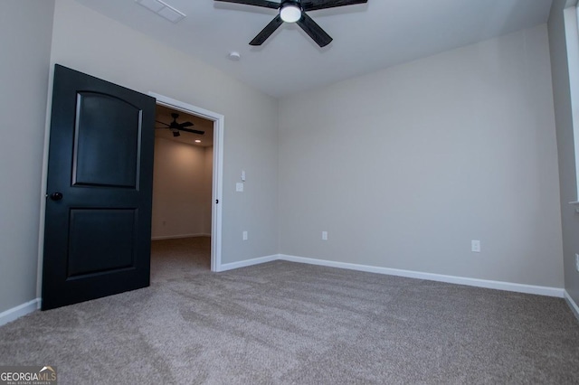 unfurnished bedroom featuring baseboards, visible vents, a ceiling fan, a spacious closet, and carpet flooring