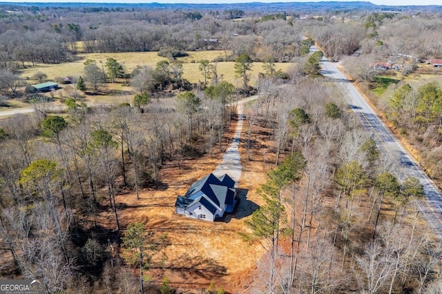 drone / aerial view featuring a rural view and a forest view