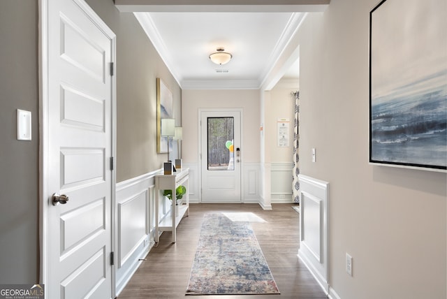 foyer with crown molding and hardwood / wood-style floors