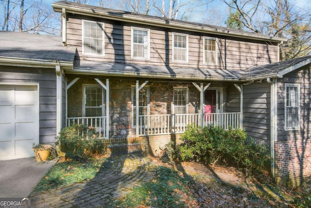 view of front of home with covered porch and a garage