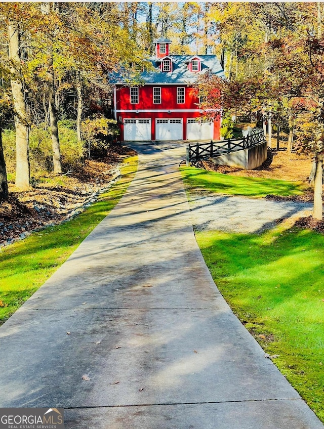 exterior space with driveway, a lawn, and an attached garage