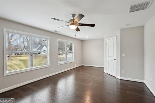 unfurnished room with ceiling fan and dark hardwood / wood-style flooring