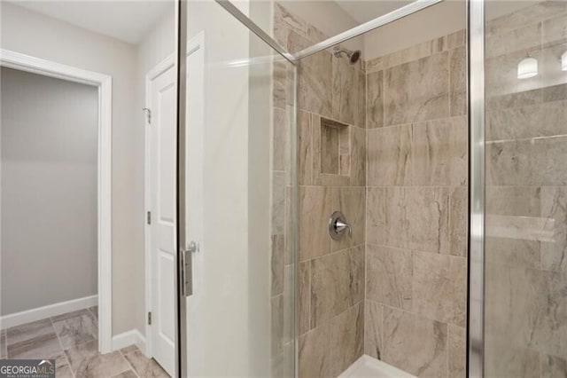 bathroom featuring a shower with shower door